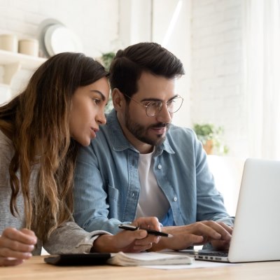 Man and woman looking at laptop