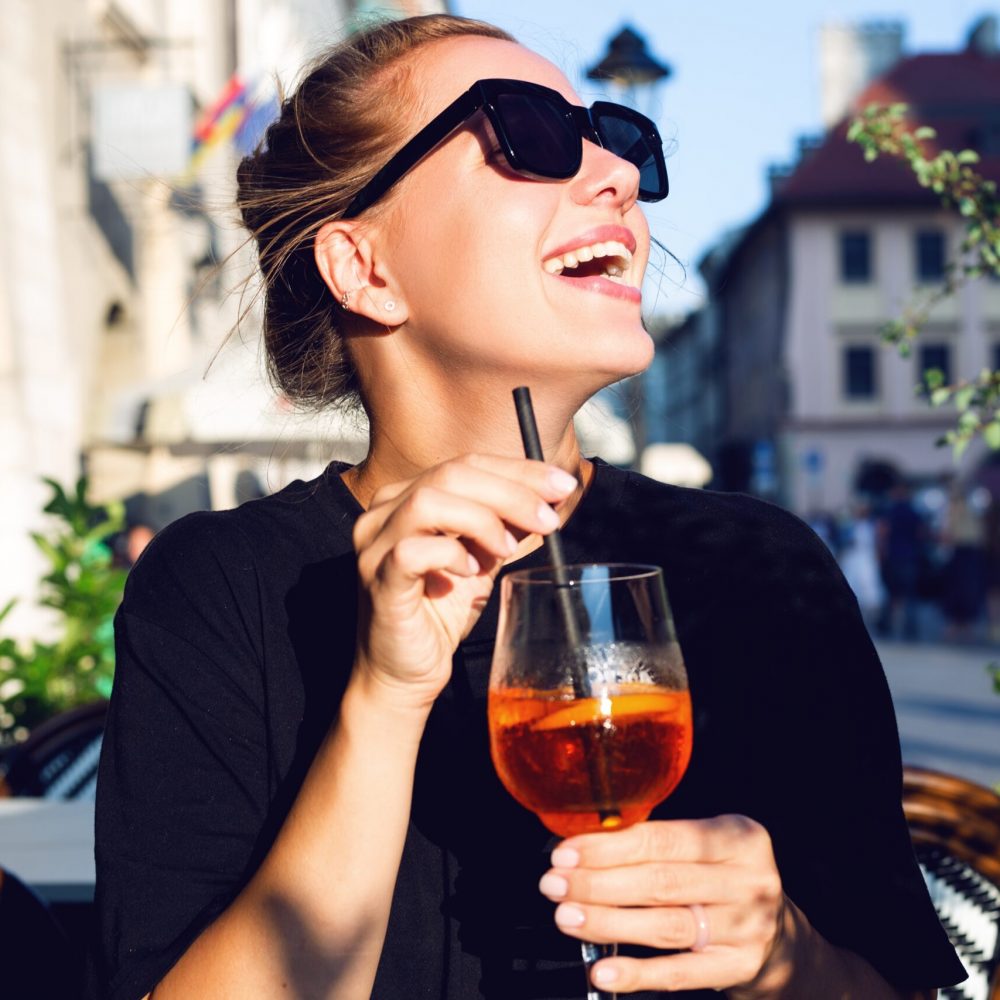 Laughing,Girl,Drinking,A,Cocktail