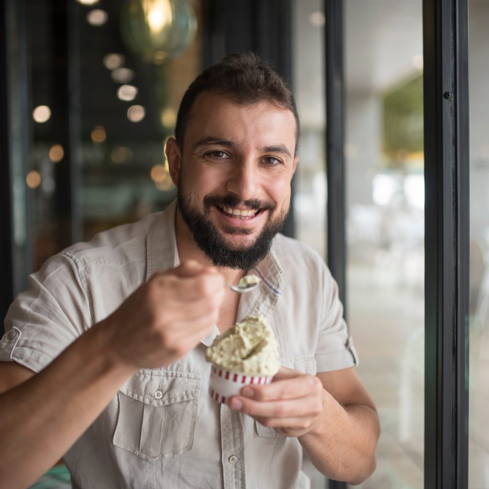 Man,With,Beard,Eating,Ice,Cream,And,Looks,At,Camera
