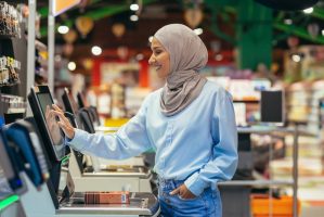 woman at self check-out at grocery store